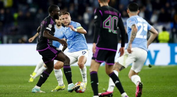 epa11153592 Bayern's Dayot Upamecano (L) and Lazio's Ciro Immobile (C) in action during the UEFA Champions League Round of 16, 1st leg soccer match SS Lazio vs FC Bayern Munich in Rome, Italy, 14 February 2024.  EPA/ANGELO CARCONI