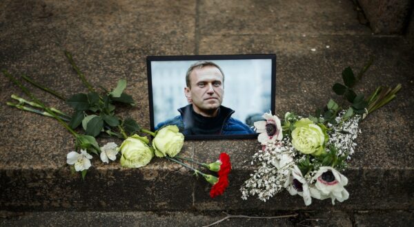 epa11158318 A portrait of Russian opposition leader and anti-corruption activist Alexey Navalny is displayed with flowers during a demonstration following the announcement of his death near the Russian Embassy in Paris, France, 16 February 2024. Russian opposition leader and outspoken Kremlin critic Alexey Navalny has died aged 47 in a penal colony, the Federal Penitentiary Service of the Yamalo-Nenets Autonomous District announced on 16 February 2024. A prison service statement said that Navalny 'felt unwell' after a walk on 16 February, and it was investigating the causes of his death. In late 2023 Navalny was transferred to an Arctic penal colony considered one of the harshest prisons.  EPA/YOAN VALAT