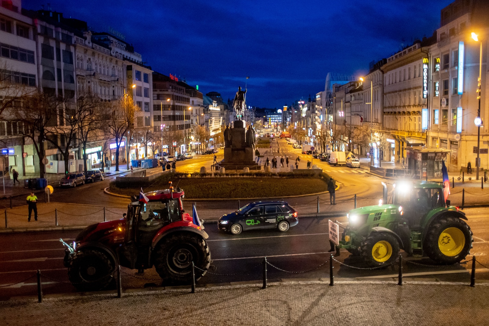 epa11165609 Czech farmers drive their tractors to block a road in downtown during a farmers' protest, in Prague, Czech Republic, 19 February 2024. The protest began early in the morning with hundreds of Czech farmers blocking both directions on a key road near the Czech Agriculture Ministry, and causing traffic jams. The action, organized by Czech agricultural trade unions, is against different subsidy environments in the EU countries and the requirements of the Green Deal for Europe.  EPA/MARTIN DIVISEK