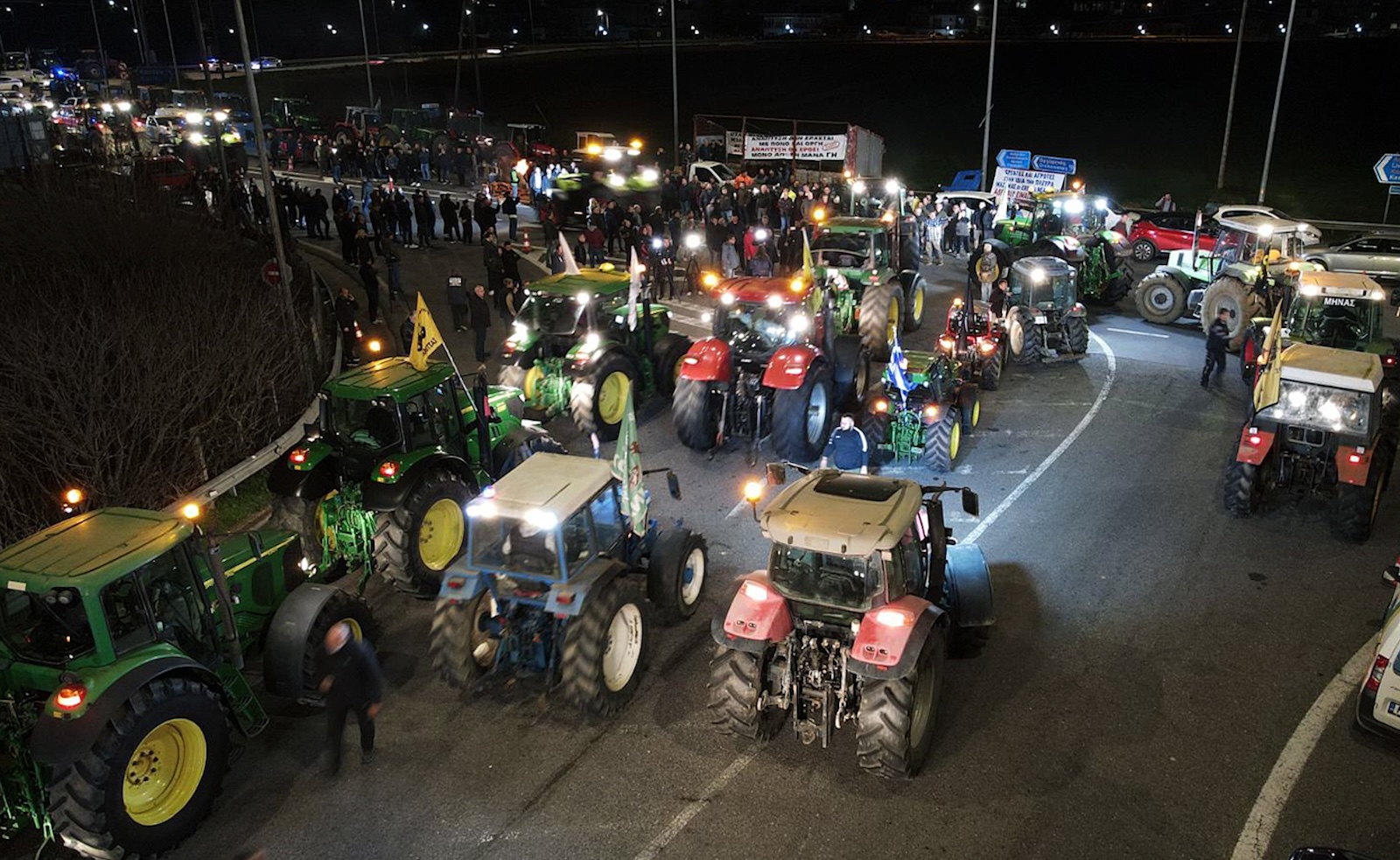epa11167099 Farmers from northern and central Greece with their tractors gather in the area of Castle of Boeotia, some 130 km north of Athens, while heading for a rally in Athens, Greece, 19 February 2024. Farmers will hold a rally in Athens on 20 February after calling for colleagues around the country to join their protest. Their demands include the lifting of the tax on agricultural diesel fuel, lower energy costs and a 100 percent reimbursement on lost livestock and crop products income. They also demand the revision of the European Union's Common Agricultural Policy.  EPA/PANAGIOTIS PRAGIANNIS