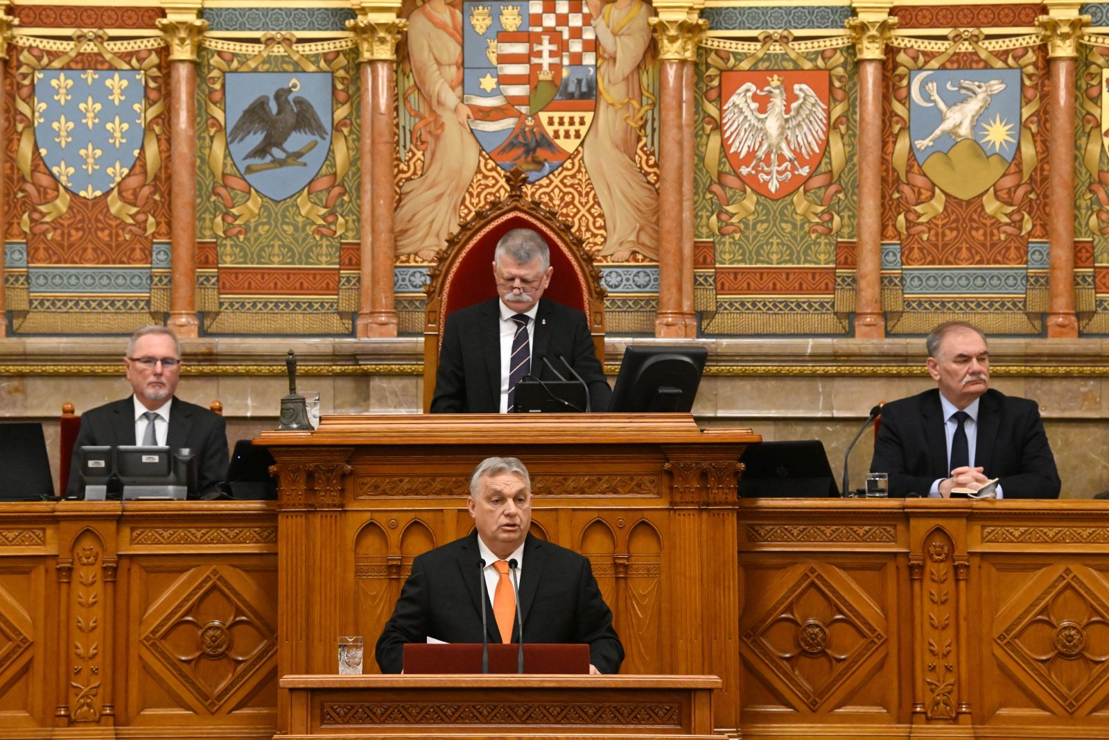 epa11182603 Hungarian Prime Minister Viktor Orban (C, front) delivers his address on the opening day of the spring session of the Hungarian Parliament in Budapest, Hungary, 26 February 2024. In picture is seen Speaker of the Parliament Laszlo Kover (C, back). Hungarian lawmakers are expected to vote about the new head of state on the day. The ruling coalition Fidesz-KDNP nominated Tamas Sulyok, the current head of the Constitutional Court for head of state.  EPA/SZILARD KOSZTICSAK HUNGARY OUT