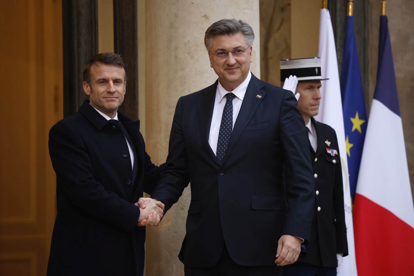 epa11183173 French President Emmanuel Macron (L) greets Croatian Prime Minister Andrej Plenkovic (C) upon his arrival at the Elysee Palace to attend the international conference in support of Ukraine in Paris, France, 26 February 2024.  EPA/YOAN VALAT