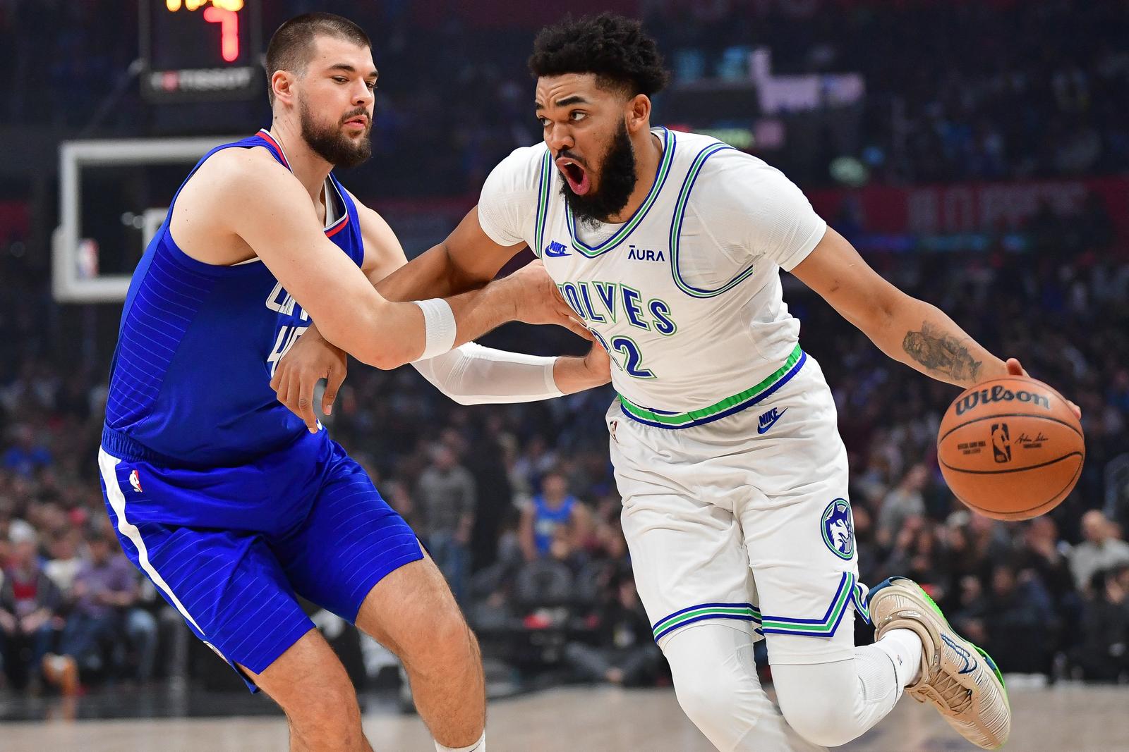 Feb 12, 2024; Los Angeles, California, USA; Minnesota Timberwolves center Karl-Anthony Towns (32) moves the ball against Los Angeles Clippers center Ivica Zubac (40) during the first half at Crypto.com Arena. Mandatory Credit: Gary A. Vasquez-USA TODAY Sports Photo: Gary A. Vasquez/REUTERS