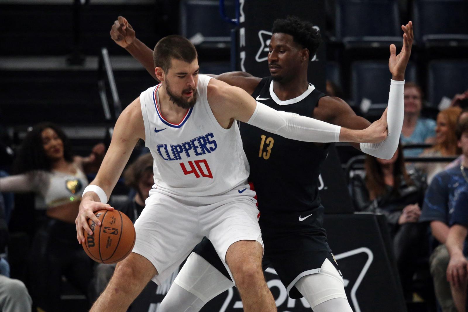 Feb 23, 2024; Memphis, Tennessee, USA; Los Angeles Clippers center Ivica Zubac (40) drives to the basket as Memphis Grizzlies forward-center Jaren Jackson Jr. (13) defends during the first half at FedExForum. Mandatory Credit: Petre Thomas-USA TODAY Sports Photo: Petre Thomas/REUTERS