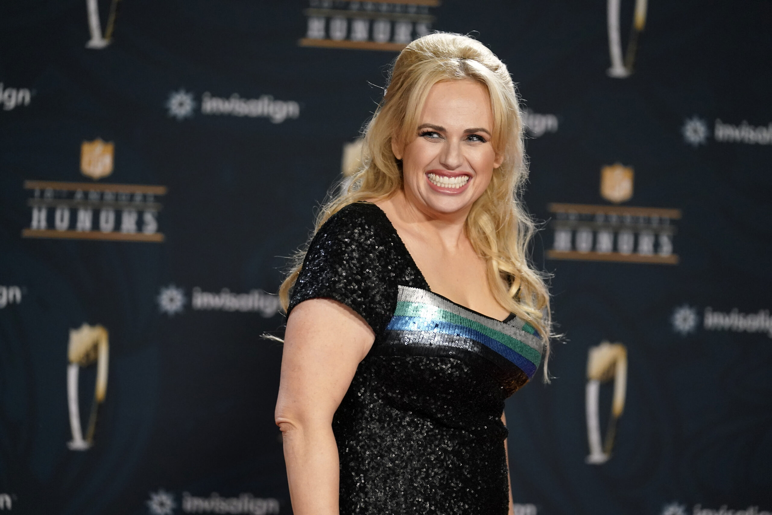 FILE - In this Tuesday, Feb. 2, 2021, file photo, Rebel Wilson poses on the red carpet during the NFL Honors football awards show, in Los Angeles. Wilson returns to her roots as host of ABC's “Pooch Perfect,” an eight-episode series featuring 10 dog groomers and their assistants competing in challenges. The show, which debuts March 30, is based on an Australian version. (AP Photo/Marcio Jose Sanchez, File)