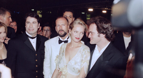 American film director Quentin Tarantino, right, arrives with his actors for his movie "Pulp Fiction" screening at the Cannes Film Festival at Cannes, France, May 21,  1994. From left: John Travolta, Bruce Willis, Uma Thurman and Tarantino. (AP Photo/Michel Lipchitz)
