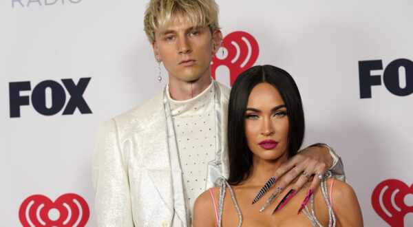 FILE - Megan Fox, right, and Machine Gun Kelly attend the iHeartRadio Music Awards on May 27, 2021, in Los Angeles. Fox and Kelly are engaged. The actor and rapper have decided to legalize their dramatically eccentric coupling, according to Instagram videos that each posted Wednesday, Jan. 12, 2022.  (AP Photo/Chris Pizzello, File)