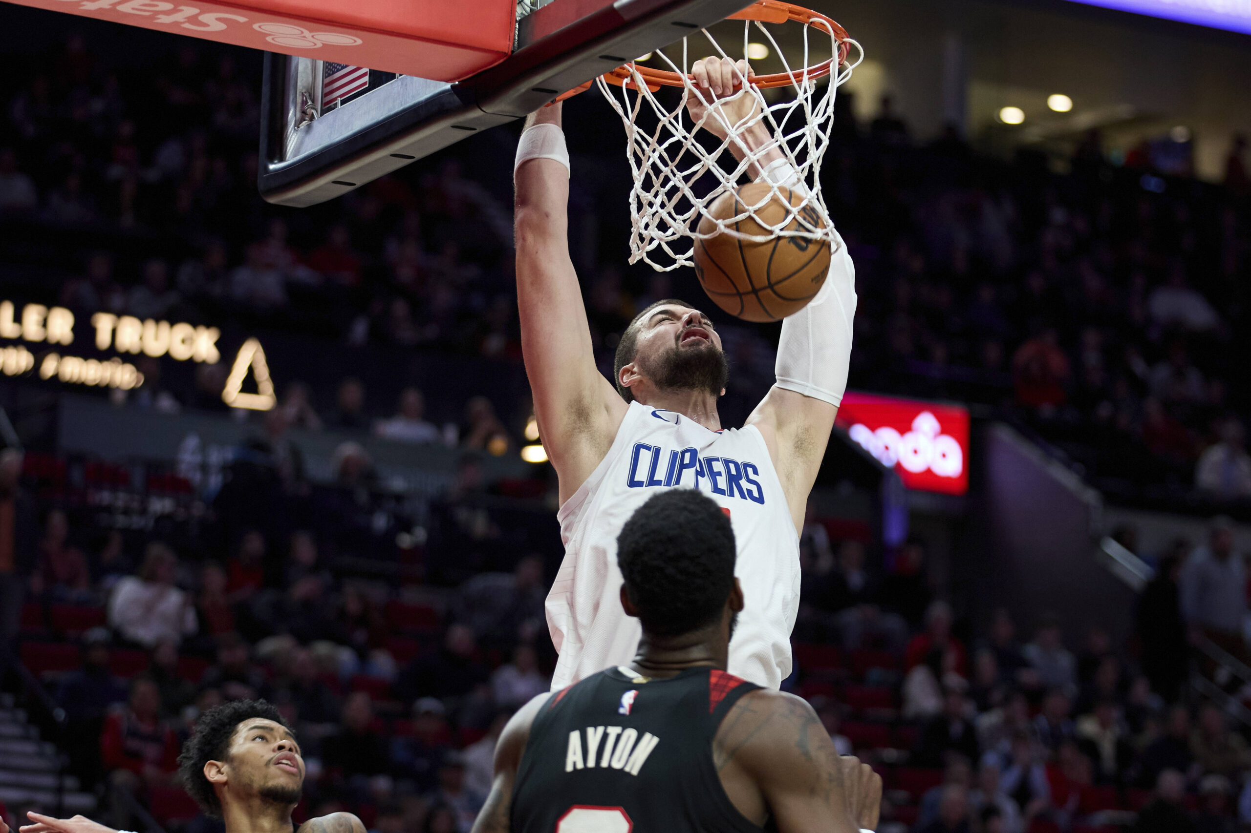 Los Angeles Clippers center Ivica Zubac dunks over Portland Trail Blazers center Deandre Ayton during the first half of an NBA basketball game in Portland, Ore., Wednesday, March 20, 2024. (AP Photo/Craig Mitchelldyer)