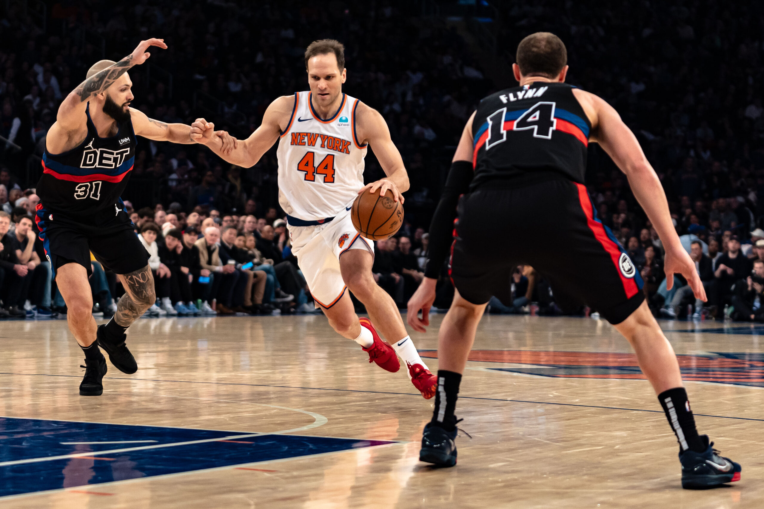 New York Knicks' Bojan Bogdanovic (44) drives to the basket against Detroit Pistons' Evan Fournier during the first half of an NBA basketball game in New York, Monday, March 25, 2024. (AP Photo/Peter K. Afriyie)