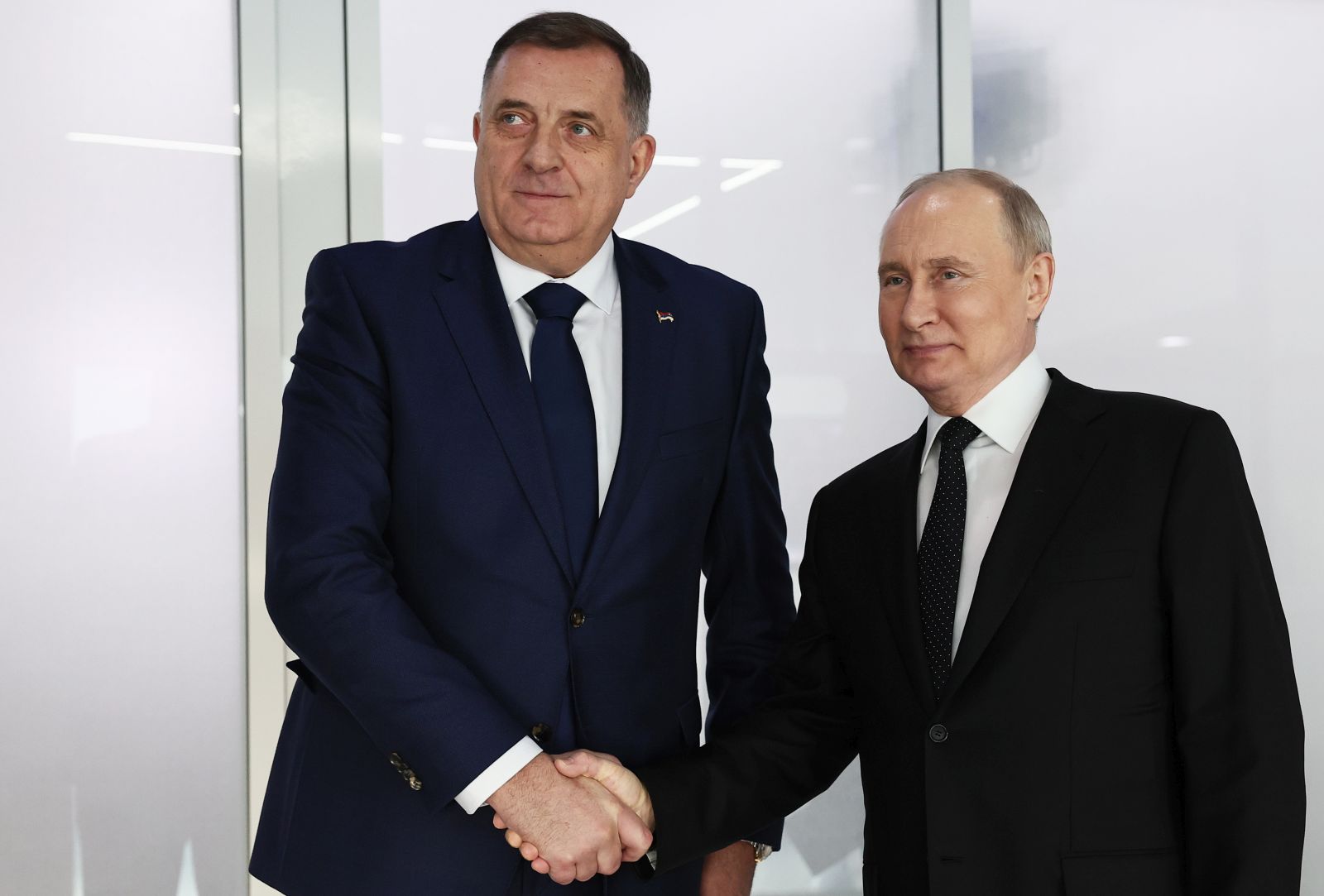 epa11170200 Russian President Vladimir Putin (R) and President of Republika Srpska (Serb Republic) Milorad Dodik shake hands as they attend a meeting at the Kazan Expo international exhibition centre in Kazan, Republic of Tatarstan, Russia, 21 February 2024. Vladimir Putin and Milorad Dodik arrived to Kazan attend opening ceremony of the Games of the Future. The phygital concept competition, the Games of the Future Kazan 2024, will be held in 21 innovative disciplines, each of which combines classic sports and e-sports, from 21 February to 03 March 2024.  EPA/SERGEI BOBYLEV/SPUTNIK/KREMLIN POOL / POOL MANDATORY CREDIT