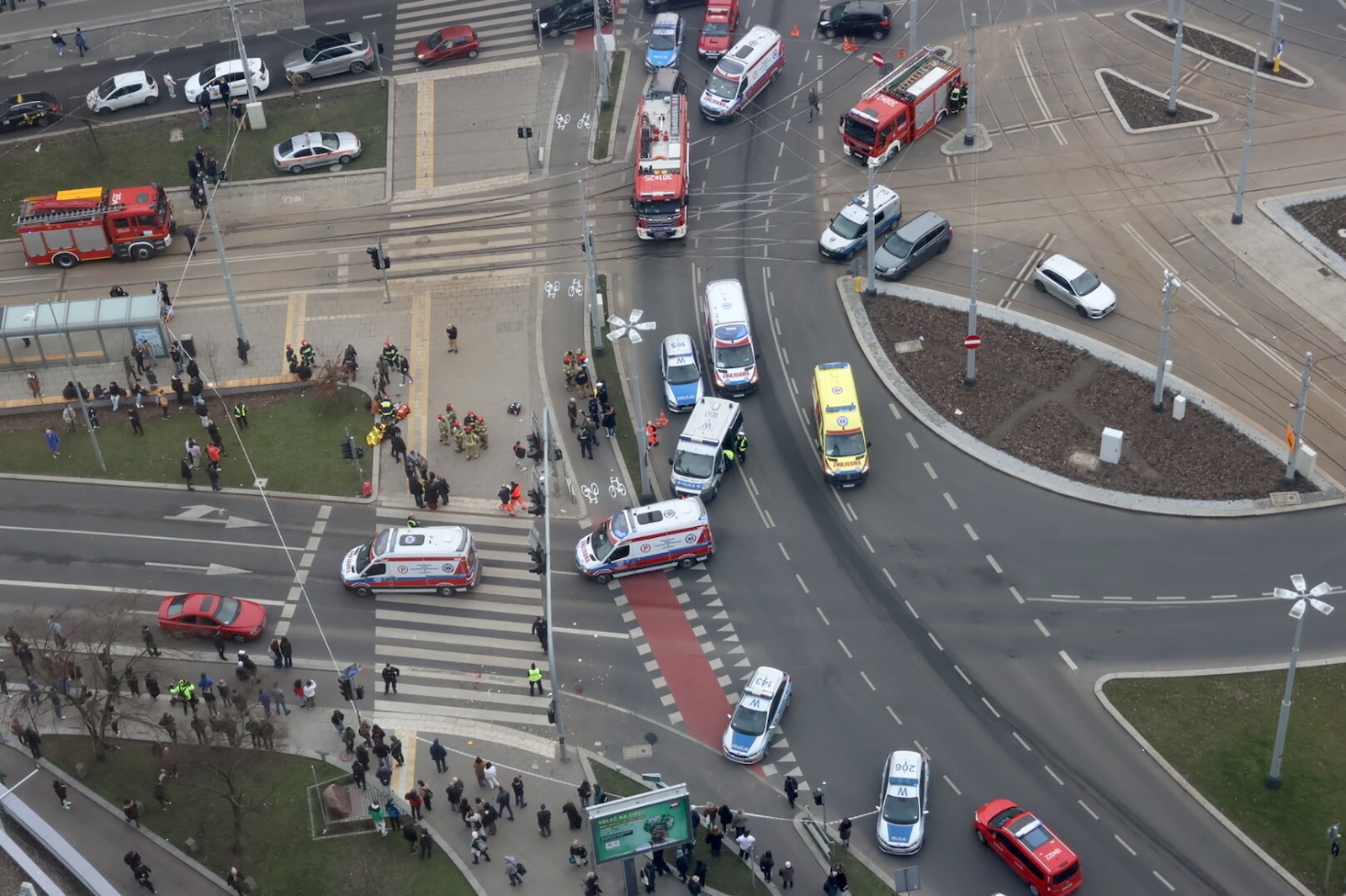 epa11191595 An aerial view of emergency services and police vehicles at the site of an accident at Rodlo Square in Szczecin, northwestern Poland, 01 March 2024. A passenger car hit a group of people at a pedestrian crossing in Szczecin. Dozens of people were injured in the incident, some in serious condition, police said. The driver, a 33-year-old resident of Szczecin, has been detained by the police.  EPA/MARCIN BIELECKI