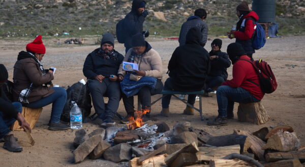 epa11199433 Migrants sit by a fire and wait for US Border Patrol in Jacumba, California, USA, 04 March 2024. According to authorities, the number of people crossing illegally into the United States from Mexico has dropped significantly over the first couple of months of 2024 as US President Biden comes under pressure from both parties over border security. President Biden has been working on a new bipartisan border security bill, but has been unable to get it passed through Congress.  EPA/ALLISON DINNER