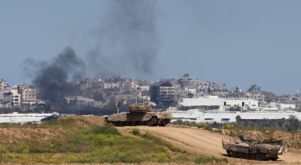 epa11213966 Smoke rises from the Gaza Strip as Israeli tanks maneuver near the border fence, as seen from an undisclosed location in southern Israel, 11 March 2024. More than 31,000 Palestinians and over 1,300 Israelis have been killed, according to the Palestinian Health Ministry and the Israel Defense Forces (IDF), since Hamas militants launched an attack against Israel from the Gaza Strip on 07 October 2023, and the Israeli operations in Gaza and the West Bank which followed it.  EPA/ABIR SULTAN