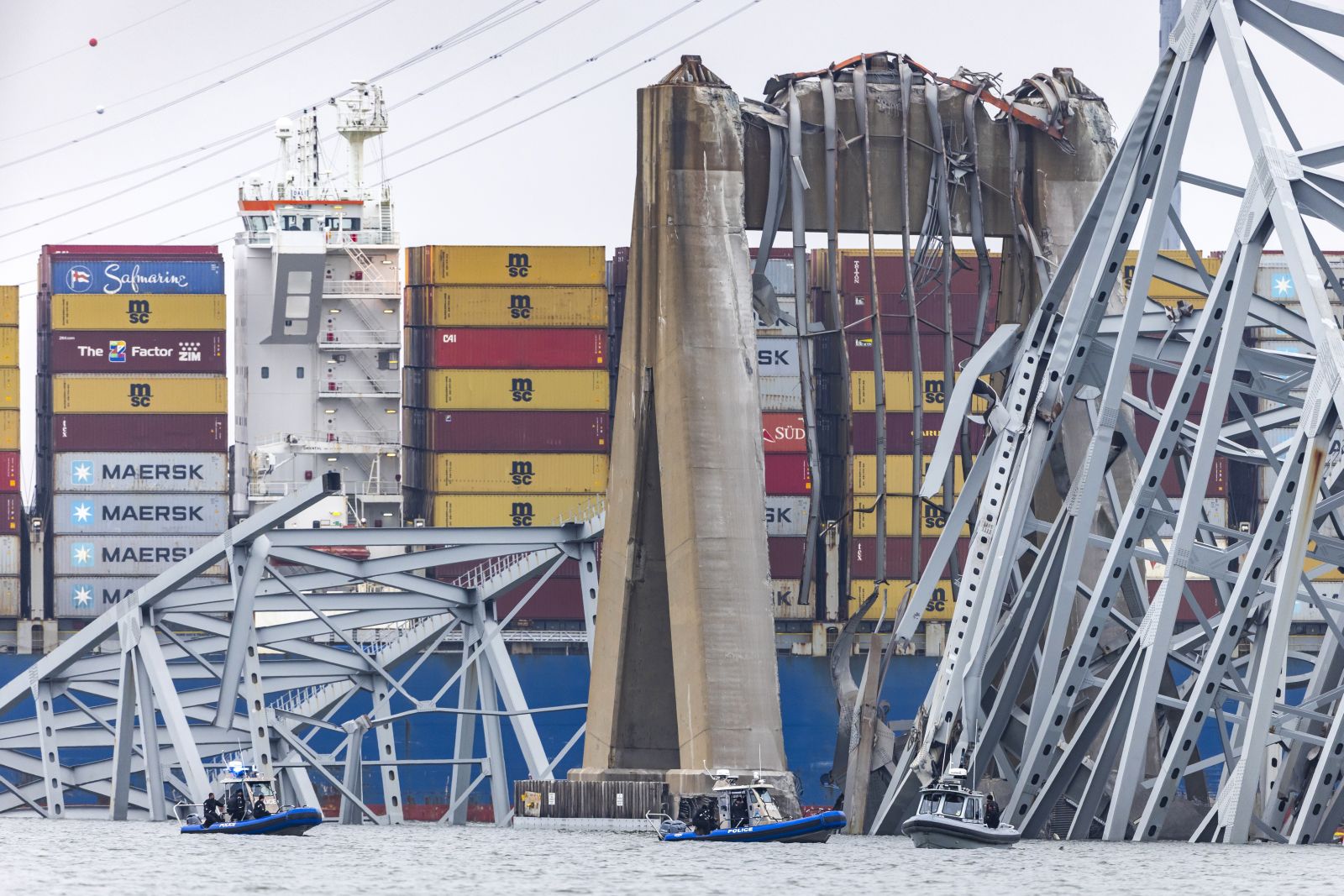 epa11246909 Wreckage from the Francis Scott Key Bridge surrounds the 984-foot cargo ship Dali after the vessel lost power and collided with the 51-year-old bridge in Baltimore, Maryland, USA, 27 March 2024. The Francis Scott Key Bridge collapsed due to a ship strike on 26 March 2024. Two people were rescued, while at least six others, all members of a construction crew working on the bridge at the time of the incident according to authorities, were still missing. Divers are working to recover the bodies of the six missing construction workers, who are now presumed dead, the US Coast Guard said.  EPA/JIM LO SCALZO