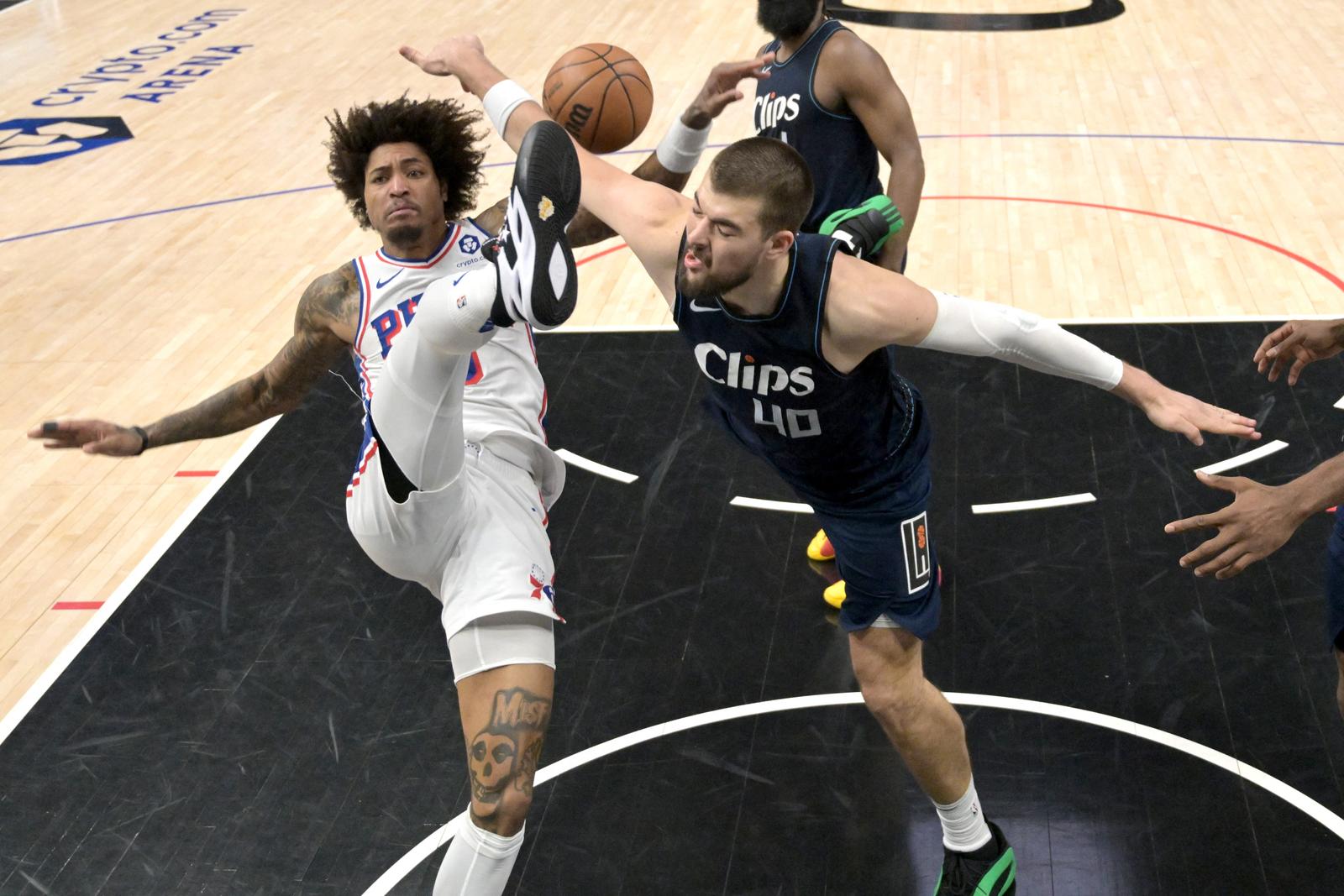 Mar 24, 2024; Los Angeles, California, USA;  Philadelphia 76ers guard Kelly Oubre Jr. (9) hits the floor as he has a shot blocked by Los Angeles Clippers center Ivica Zubac (40) in the second half at Crypto.com Arena. Mandatory Credit: Jayne Kamin-Oncea-USA TODAY Sports Photo: Jayne Kamin-Oncea/REUTERS