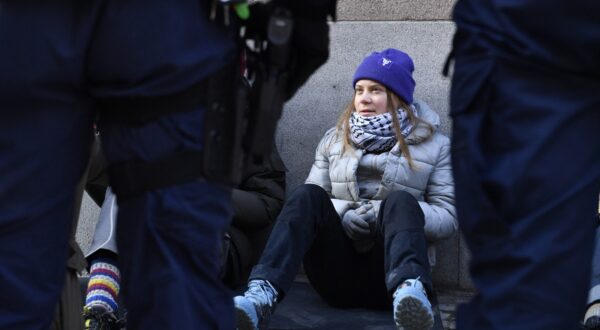 Swedish climate activist Greta Thunberg looks at policemen as she sits outside the Swedish parliament, the Riksdagen, to demonstrate for climate action, on March 12, 2024 in Stockholm, Sweden.,Image: 856121108, License: Rights-managed, Restrictions: Sweden OUT, Model Release: no, Credit line: Samuel STEEN / AFP / Profimedia