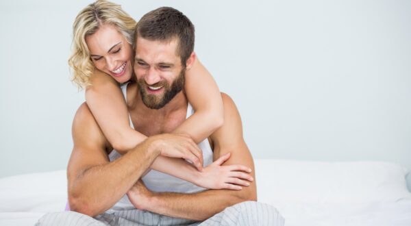 Young couple embracing on bed at bedroom,Image: 282381127, License: Royalty-free, Restrictions: , Model Release: yes, Credit line: - / Wavebreak / Profimedia