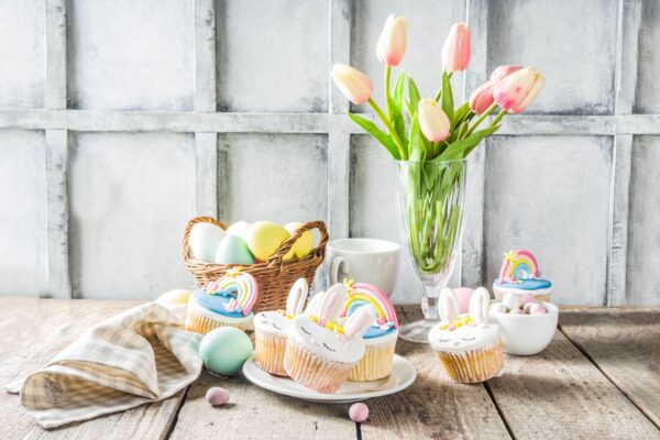 Easter holiday greeting card background. Cute homemade cupcakes with traditional Easter bunny, egg and springtime flowers decor. Happy easter concept. Copy space for your text,Image: 489619934, License: Royalty-free, Restrictions: , Model Release: no, Credit line: Rimma Bondarenko / Alamy / Alamy / Profimedia
