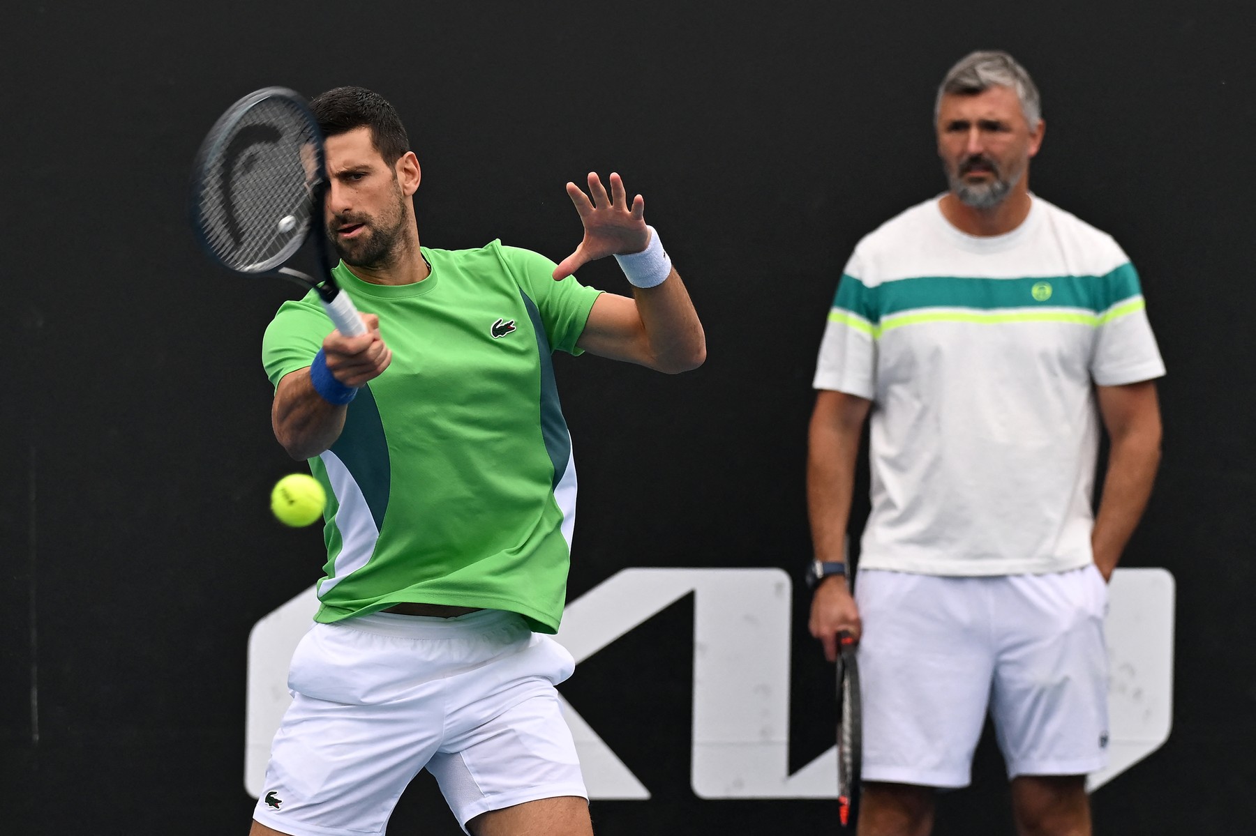 Serbia's Novak Djokovic attends a training session next to his coach Goran Ivanisevic (R) on day 12 of the Australian Open tennis tournament in Melbourne on January 25, 2024.,Image: 840314153, License: Rights-managed, Restrictions: -- IMAGE RESTRICTED TO EDITORIAL USE - STRICTLY NO COMMERCIAL USE --, Model Release: no, Credit line: Paul Crock / AFP / Profimedia