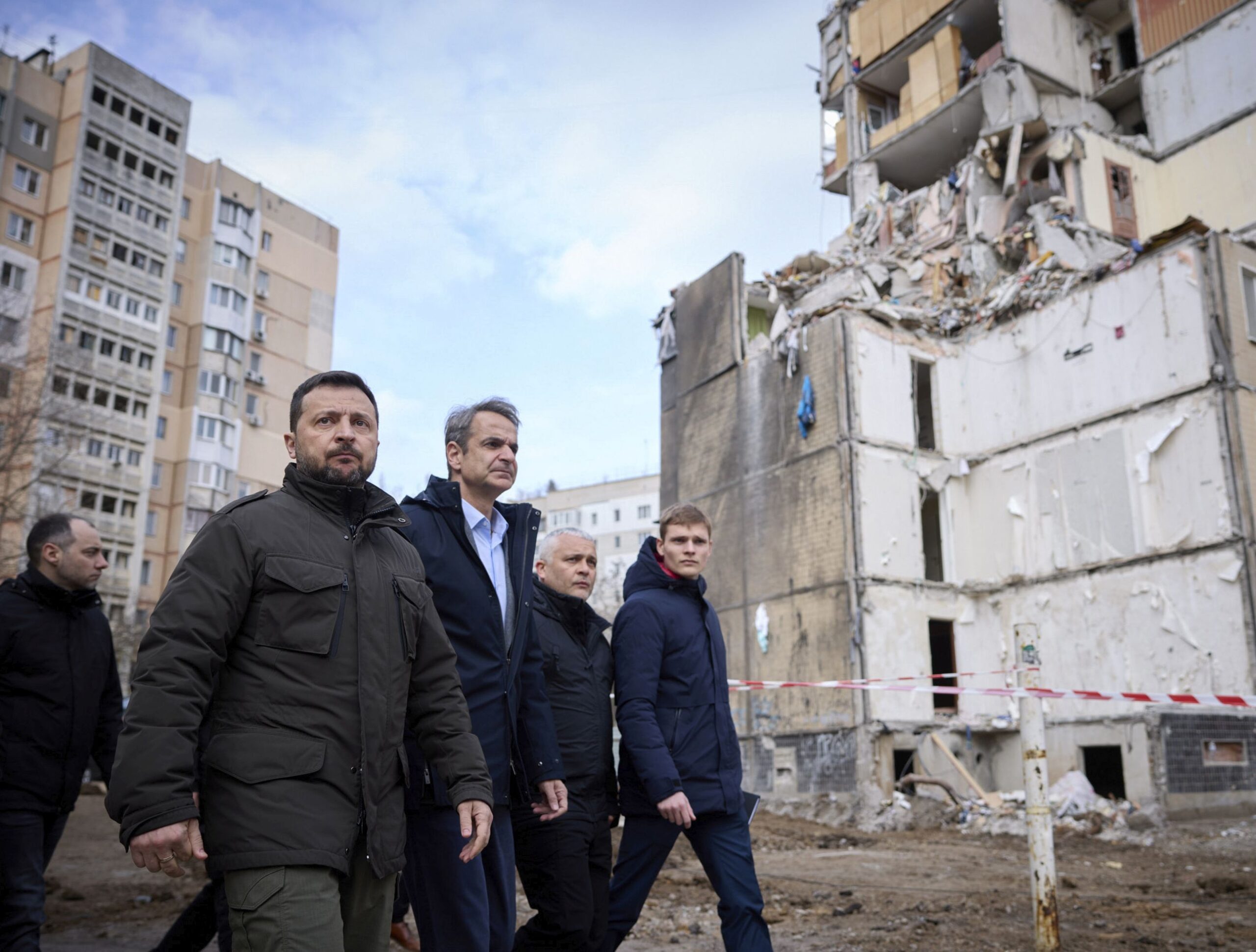 epa11202343 A handout photo made available by the presidential press service shows Ukrainian President Volodymyr Zelensky (L) and Greek Prime Minister Kyriakos Mitsotakis (2-L) walking in front of a damaged residential building at a site hit in a Russian drone attack on 02 March 2024, in Odesa, Ukraine, 06 March 2024. Twelve people died, including five children, and eight others were injured in the drone attack. The Greek prime minister arrived in Odesa to meet with top Ukrainian officials amid the Russian invasion.  EPA/PRESIDENTIAL PRESS SERVICE HANDOUT   HANDOUT EDITORIAL USE ONLY/NO SALES HANDOUT EDITORIAL USE ONLY/NO SALES