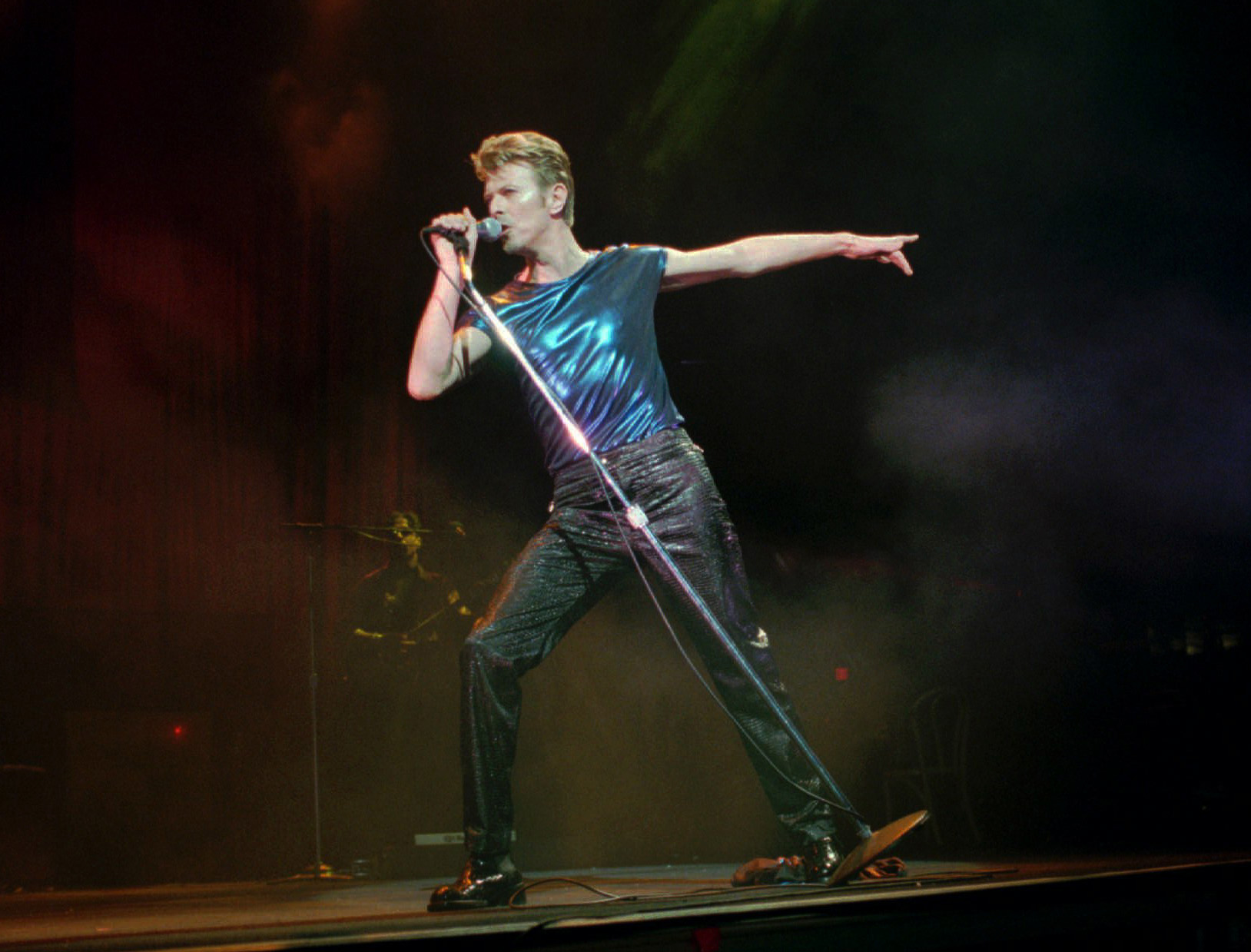 CORRECTS DATE OF DEATH TO SUNDAY, JAN. 10, 2016 - FILE - In this Sept. 14, 1995, file photo, David Bowie performs in Hartford, Conn. Bowie, the innovative and iconic singer whose illustrious career lasted five decades, died Sunday, Jan. 10, 2016, after battling cancer for 18 months. He was 69. (AP Photo/Bob Child, File)