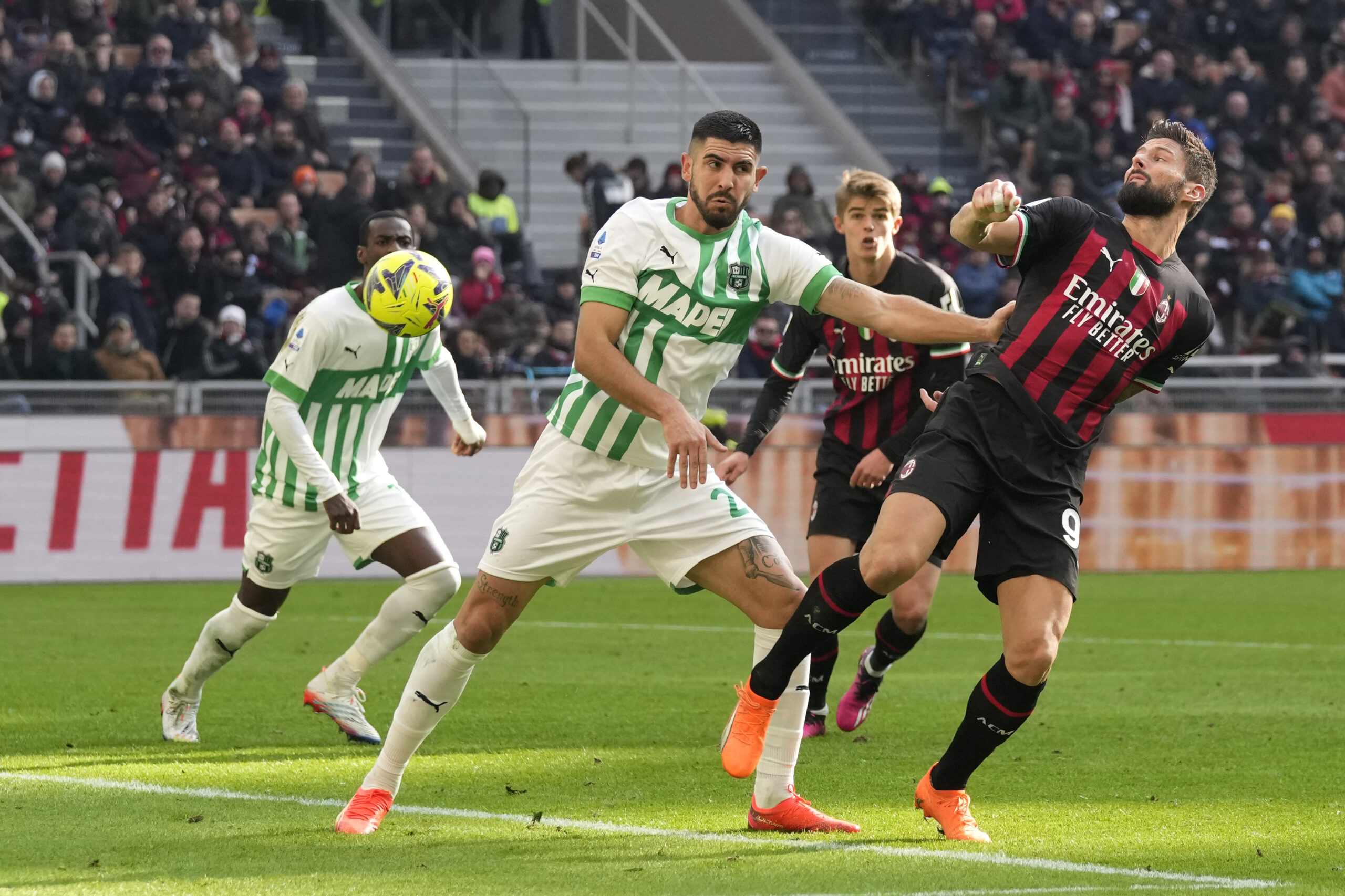 AC Milan's Olivier Giroud, right, and Sassuolo's Martin Erlic vie for the ball during a Serie A soccer match between AC Milan and Sassuolo at the San Siro stadium in Milan, Italy, Sunday, Jan. 29, 2023. (AP Photo/Antonio Calanni)