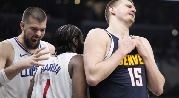 Los Angeles Clippers guard James Harden, center, celebrates with center Ivica Zubac, left, after scoring as Denver Nuggets center Nikola Jokic reacts to getting a foul called against him during the second half of an NBA basketball game Thursday, April 4, 2024, in Los Angeles. (AP Photo/Mark J. Terrill)