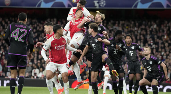 Arsenal's Kai Havertz, up, and Bayern's Harry Kane, right, challenge for the ball during the Champions League quarter final first leg soccer match between Arsenal and Bayern Munich at the Emirates Stadium, London, Tuesday, April 9, 2024. (AP Photo/Frank Augstein)