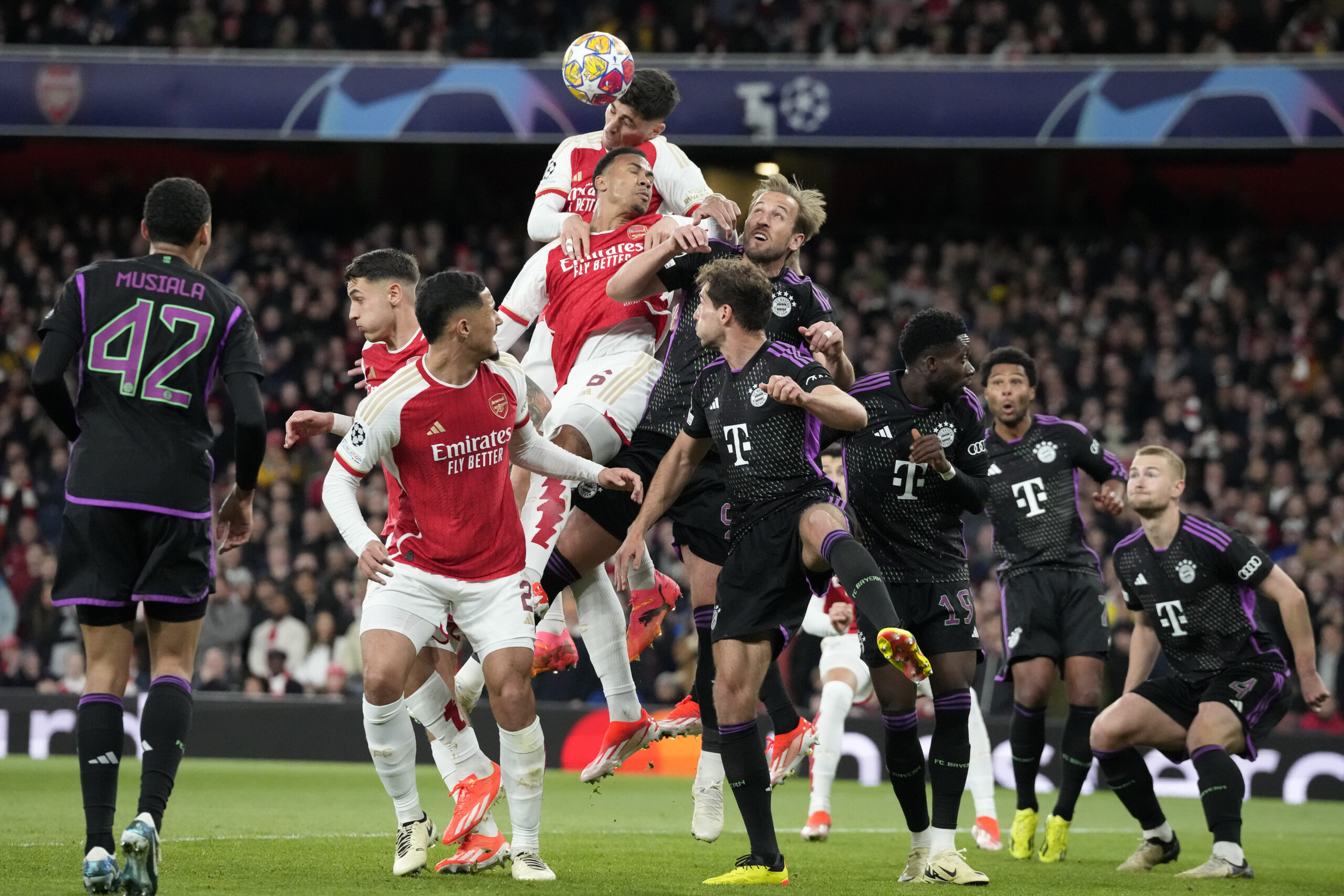 Arsenal's Kai Havertz, up, and Bayern's Harry Kane, right, challenge for the ball during the Champions League quarter final first leg soccer match between Arsenal and Bayern Munich at the Emirates Stadium, London, Tuesday, April 9, 2024. (AP Photo/Frank Augstein)