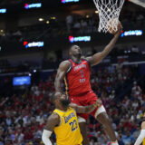 New Orleans Pelicans forward Zion Williamson (1) goes to the basket over Los Angeles Lakers forward LeBron James (23) in the second half of an NBA basketball play-in tournament game Tuesday, April 16, 2024, in New Orleans. The Lakers won 110-106. (AP Photo/Gerald Herbert)