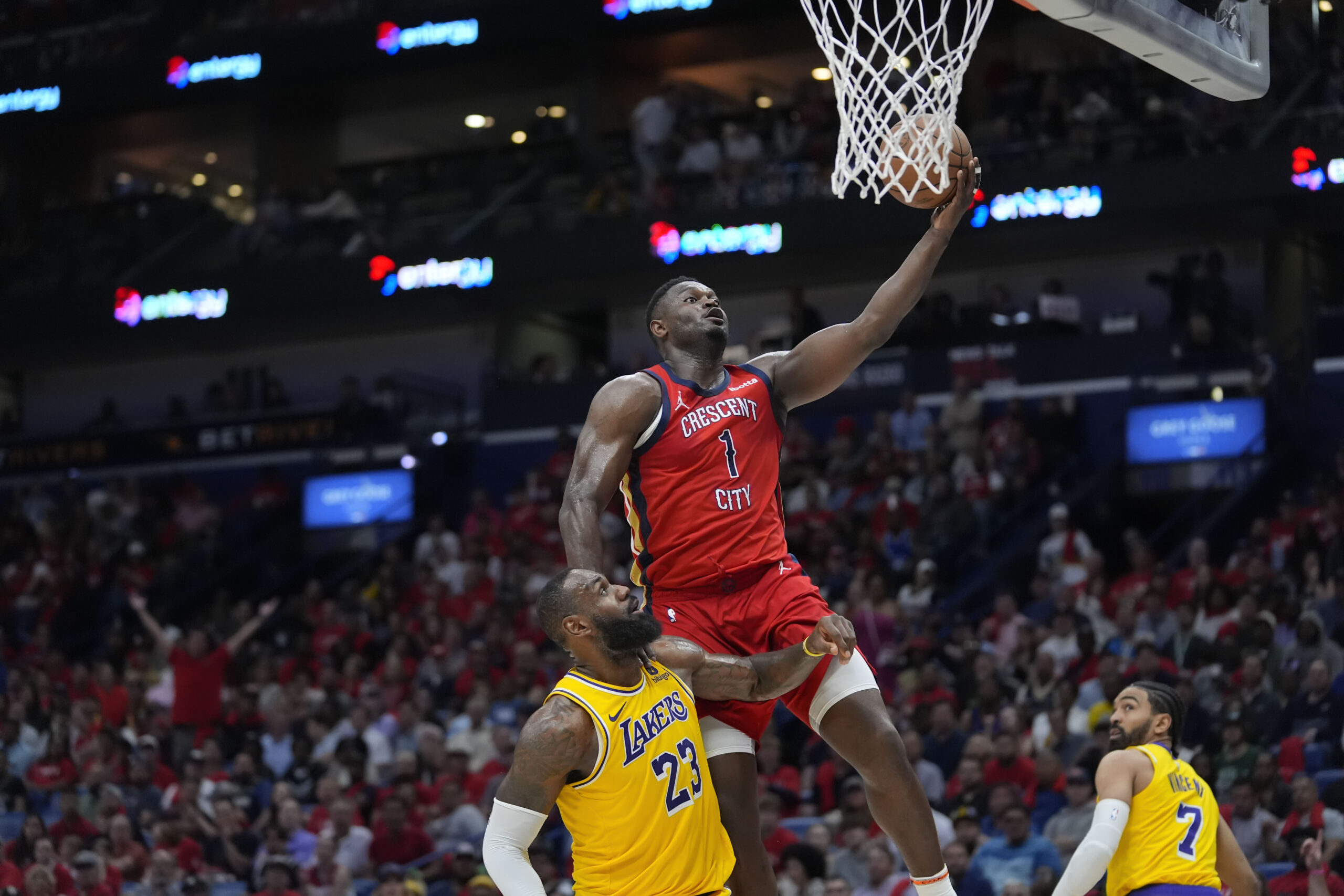 New Orleans Pelicans forward Zion Williamson (1) goes to the basket over Los Angeles Lakers forward LeBron James (23) in the second half of an NBA basketball play-in tournament game Tuesday, April 16, 2024, in New Orleans. The Lakers won 110-106. (AP Photo/Gerald Herbert)
