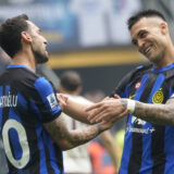 Inter Milan's Hakan Calhanoglu, left, celebrates with Inter Milan's Lautaro Martinez after scoring his side's second goal from a penalty kick during a Serie A soccer match between Inter Milan and Torino at the San Siro stadium in Milan, Italy, Sunday, April 28, 2024. (AP Photo/Luca Bruno)
