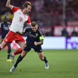 Bayern's Harry Kane, left, challenges for the ball with Real Madrid's Toni Kroos during the Champions League semifinal first leg soccer match between Bayern Munich and Real Madrid at the Allianz Arena in Munich, Germany, Tuesday, April 30, 2024. (AP Photo/Christian Bruna)