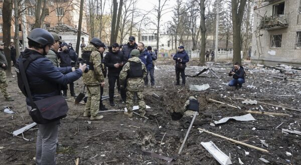 epa11247043 Police secure the site of shelling near residential buildings in Kharkiv, Ukraine, 27 March 2024, amid the Russian invasion. At least one man was killed and 16 others injured, including four children, after  Russian shelling on the Kharkiv district by an unidentified weapon, presumed to be the new UMPB D-30SN glide bomb, according to the head of the Kharkiv military administration, Oleg Synegubov. Russian troops entered Ukrainian territory on 24 February 2022, starting a conflict that has provoked destruction and a humanitarian crisis.  EPA/SERGEY KOZLOV