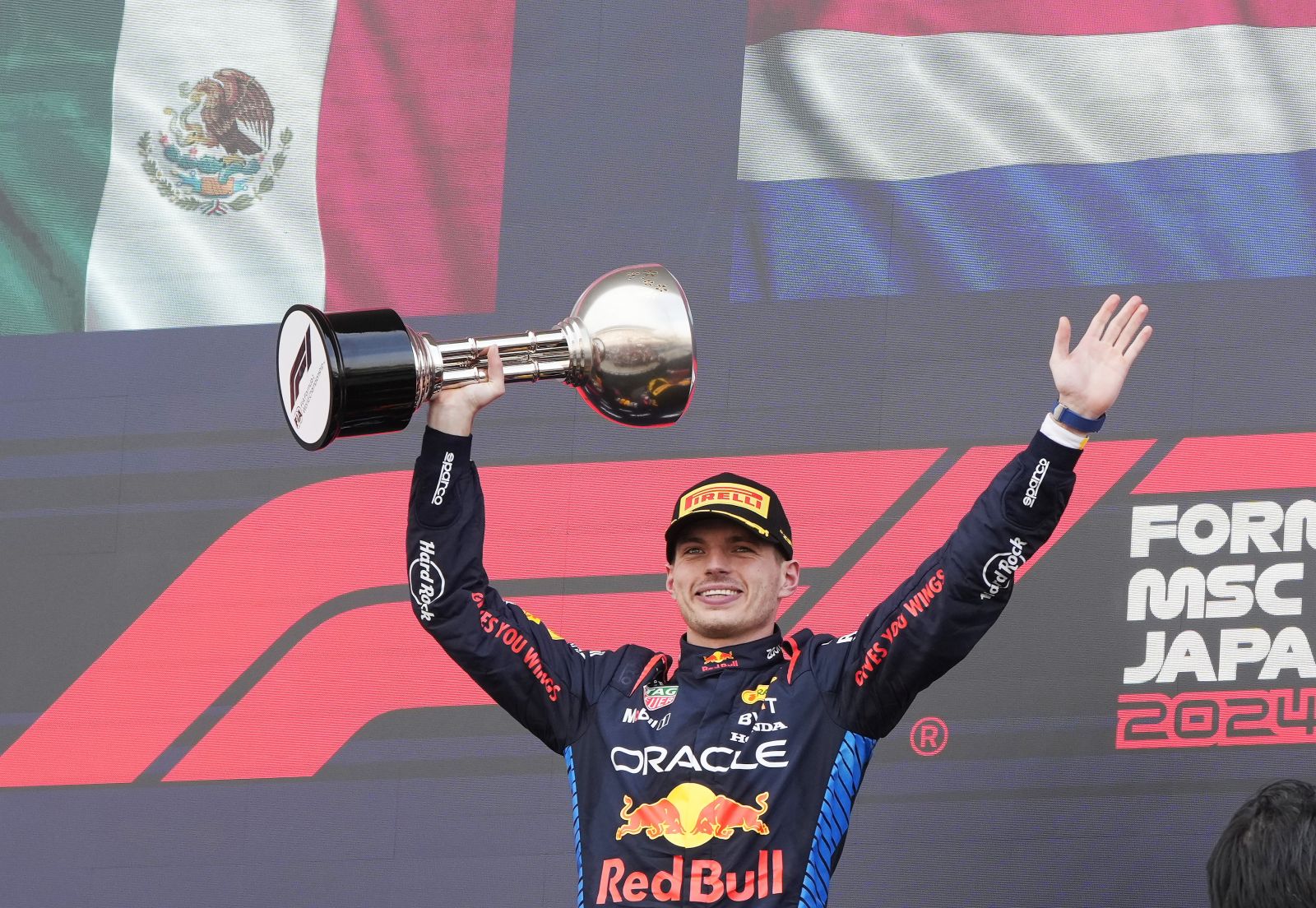 epa11263562 First place Red Bull Racing driver Max Verstappen of the Netherlands celebrates with his trophy on the podium after the Formula One Japanese Grand Prix at the Suzuka International Racing Course in Suzuka, Japan, 07 April 2024.  EPA/FRANCK ROBICHON
