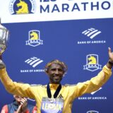 epa11280668 Sisay Lemma of Ethiopia celebrates with his trophy on the podium after winning the Men’s division of the 128th Boston Marathon in Boston, Massachusetts, USA, 15 April 2024.  EPA/CJ GUNTHER
