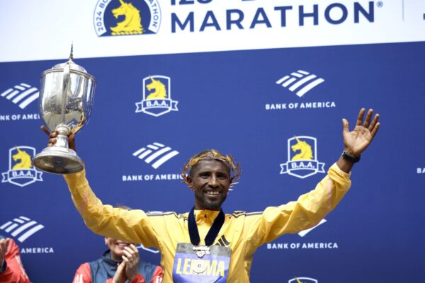 epa11280668 Sisay Lemma of Ethiopia celebrates with his trophy on the podium after winning the Men’s division of the 128th Boston Marathon in Boston, Massachusetts, USA, 15 April 2024.  EPA/CJ GUNTHER