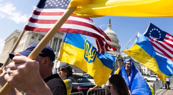 epa11290792 Supporters of Ukraine wave US and Ukrainian flags outside the US Capitol after the House approved foreign aid packages to Ukraine, as well as Israel and Taiwan in the US Capitol in Washington, DC, USA, 20 April 2024. Senate Majority Leader Chuck Schumer has vowed to advance the foreign aid packages as soon as next week.  EPA/JIM LO SCALZO