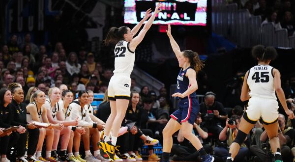 Apr 5, 2024; Cleveland, OH, USA; Iowa Hawkeyes guard Caitlin Clark (22) shoots a three pointer against Connecticut Huskies guard Ashlynn Shade (12) in the third quarter in the semifinals of the Final Four of the womens 2024 NCAA Tournament at Rocket Mortgage FieldHouse. Mandatory Credit: Kirby Lee-USA TODAY Sports Photo: Kirby Lee/REUTERS