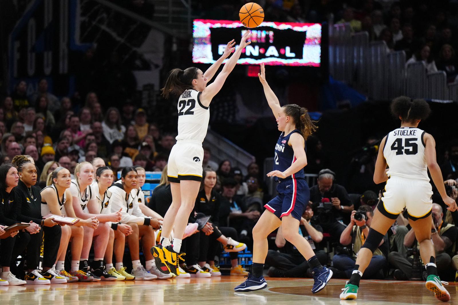 Apr 5, 2024; Cleveland, OH, USA; Iowa Hawkeyes guard Caitlin Clark (22) shoots a three pointer against Connecticut Huskies guard Ashlynn Shade (12) in the third quarter in the semifinals of the Final Four of the womens 2024 NCAA Tournament at Rocket Mortgage FieldHouse. Mandatory Credit: Kirby Lee-USA TODAY Sports Photo: Kirby Lee/REUTERS