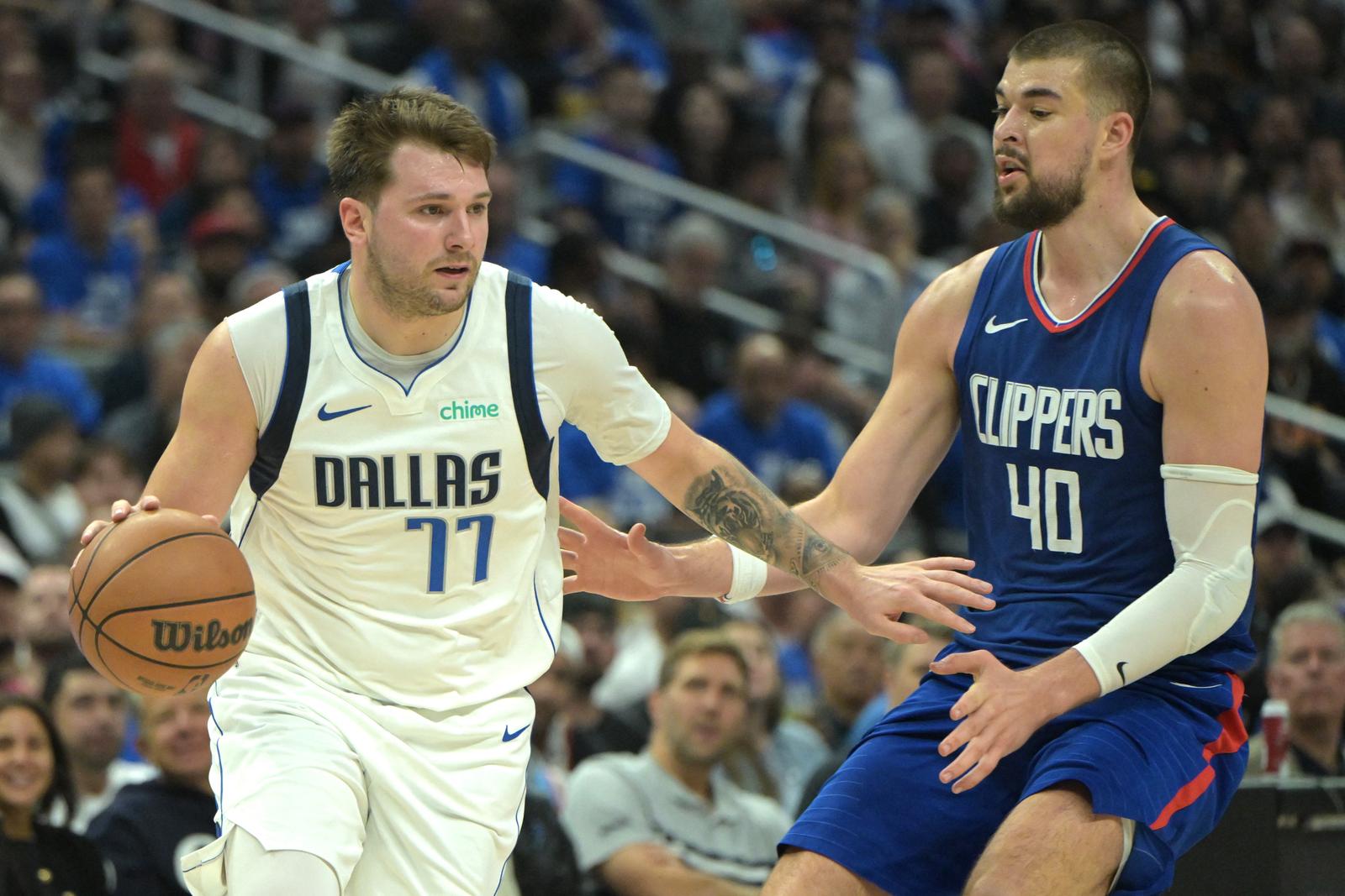 Apr 21, 2024; Los Angeles, California, USA; Dallas Mavericks guard Luka Doncic (77) is defended by Los Angeles Clippers center Ivica Zubac (40) in the second half of game one of the first round for the 2024 NBA playoffs at Crypto.com Arena. Mandatory Credit: Jayne Kamin-Oncea-USA TODAY Sports Photo: Jayne Kamin-Oncea/REUTERS