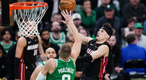 Apr 24, 2024; Boston, Massachusetts, USA; Miami Heat guard Tyler Herro (14) drives to the basket against Boston Celtics center Kristaps Porzingis (8) in the second half during game two of the first round for the 2024 NBA playoffs at TD Garden. Mandatory Credit: David Butler II-USA TODAY Sports Photo: David Butler II/REUTERS