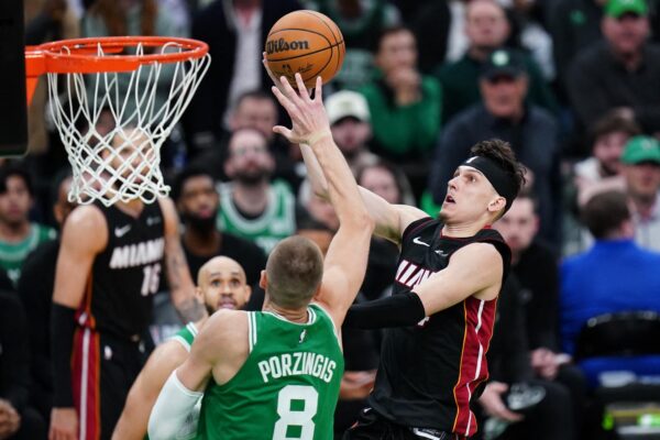 Apr 24, 2024; Boston, Massachusetts, USA; Miami Heat guard Tyler Herro (14) drives to the basket against Boston Celtics center Kristaps Porzingis (8) in the second half during game two of the first round for the 2024 NBA playoffs at TD Garden. Mandatory Credit: David Butler II-USA TODAY Sports Photo: David Butler II/REUTERS