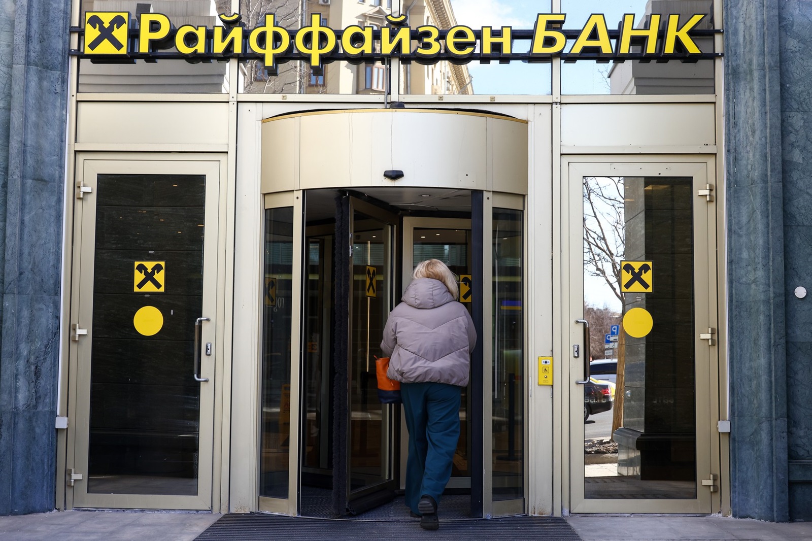 RUSSIA, MOSCOW - MARCH 12, 2024: A woman enters an office of Raiffeisenbank, a subsidiary of Austria's Raiffeisen Bank International, in Smolenskaya-Sennaya Square. Raiffeisen Bank International has denied media reports of the US Treasury Department threats to impose sanctions against the bank due to its operation in Russia. Artyom Geodakyan/TASS,Image: 856165052, License: Rights-managed, Restrictions: , Model Release: no, Credit line: Artyom Geodakyan / TASS / Profimedia
