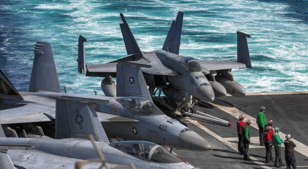 In this photo obtained from the US Department of Defense, US Navy F/A-18 Hornet multirole combat aircraft are pictured on the deck of the aircraft carrier USS Dwight D. Eisenhower (CVN 69) (IKE) transits the Strait of Hormuz on November 26, 2023. The United States said on November 29 that an Iranian drone flew dangerously close to the USS Dwight D. Eisenhower aircraft carrier the day before. The Eisenhower is the centerpiece of one of two carrier strike groups deployed as part of US efforts to deter Iran and its proxy forces in the Middle East from escalating the Israel-Hamas war into a broader regional conflict.,Image: 828825275, License: Rights-managed, Restrictions: RESTRICTED TO EDITORIAL USE - MANDATORY CREDIT 