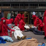 Climate activists from the group Extinction Rebellion (XR) and the Red Rebel Brigade hold a “die in” during 