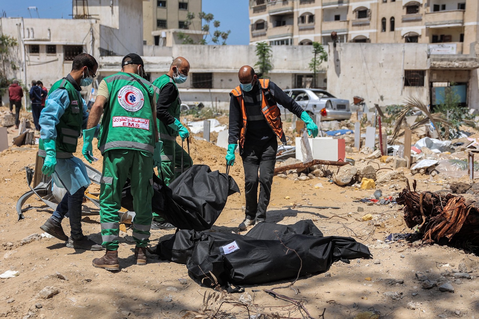 Palestinian paramedics carry away bodies of dead people uncovered in the vicinity of Al-Shifa Hospital in Gaza City on April 17, 2024 after the recent Israeli military operation there amid the ongoing fighting in the Palestinian territory between Israel and the militant group Hamas.,Image: 865665312, License: Rights-managed, Restrictions: Graphic Content, Model Release: no, Credit line: AFP / AFP / Profimedia