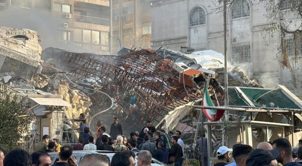 Emergency and security personnel gather at the site of strikes which hit a building adjacent to the Iranian embassy in Syria's capital Damascus, on April 1, 2024. Israeli strikes hit Syria's capital on April 1, state media reported, as a war monitor said six people were killed in a building adjacent to the Iranian embassy.,Image: 861588127, License: Rights-managed, Restrictions: , Model Release: no, Credit line: Maher AL MOUNES / AFP / Profimedia