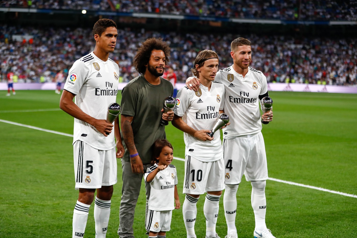September 29, 2018 - Raphael Varane, Marcelo, Luka Modric and Sergio Ramos of Real Madrid with trophy during the La Liga (Spanish Championship) football match between Real Madrid and Atletico de Madrid on September 29th, 2018 at Santiago Bernabeu stadium in Madrid, Spain.,Image: 389062959, License: Rights-managed, Restrictions: , Model Release: no, Credit line: AFP7 / Zuma Press / Profimedia