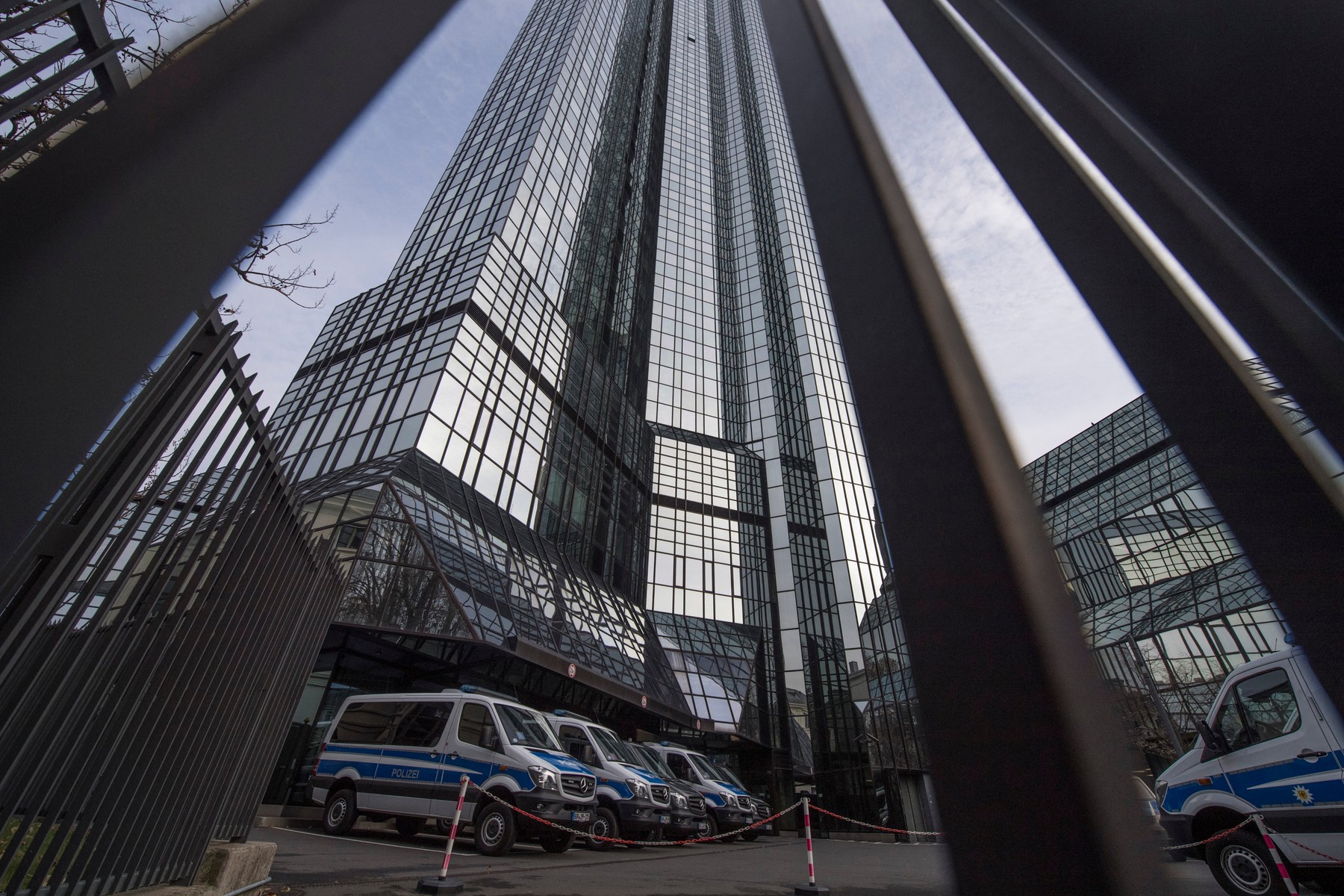 Police vehicles are parked at Deutsche Bank's headquarters in Frankfurt on November 29, 2018.  German prosecutors raided several Deutsche Bank offices in the Frankfurt area on November 29, 2018 over suspicions of money laundering based on revelations from the 2016 "Panama Papers" data leak.,Image: 399034769, License: Rights-managed, Restrictions: Germany OUT, Model Release: no, Credit line: Boris Roessler / AFP / Profimedia
